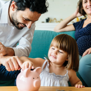 pregnant mom, dad, and daughter saving money